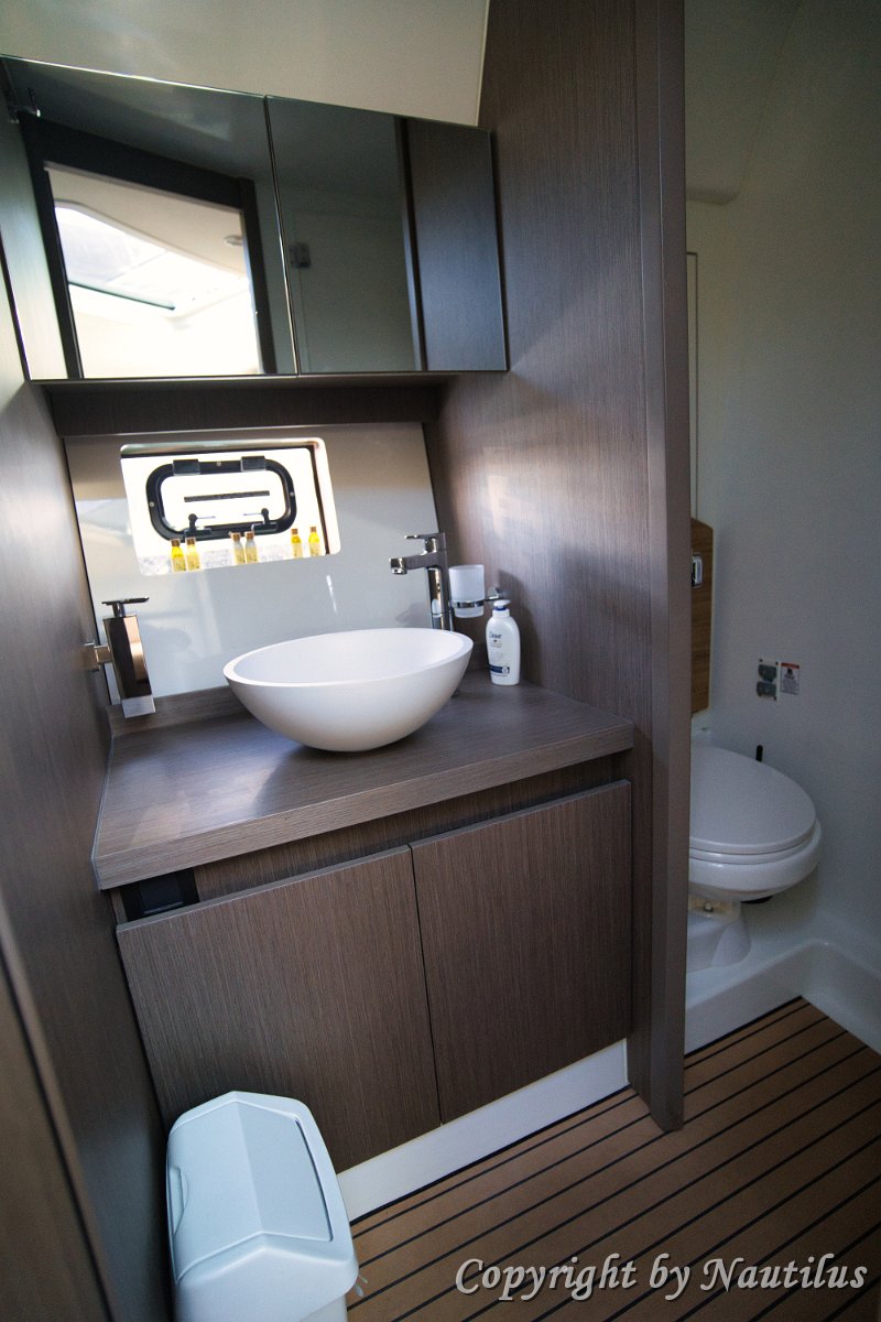 Bathroom & Shower - Beneteau 'Miami Vice' Well-appointed bathroom featuring storage cabinets and a separate shower area on the Gran Turismo 41.