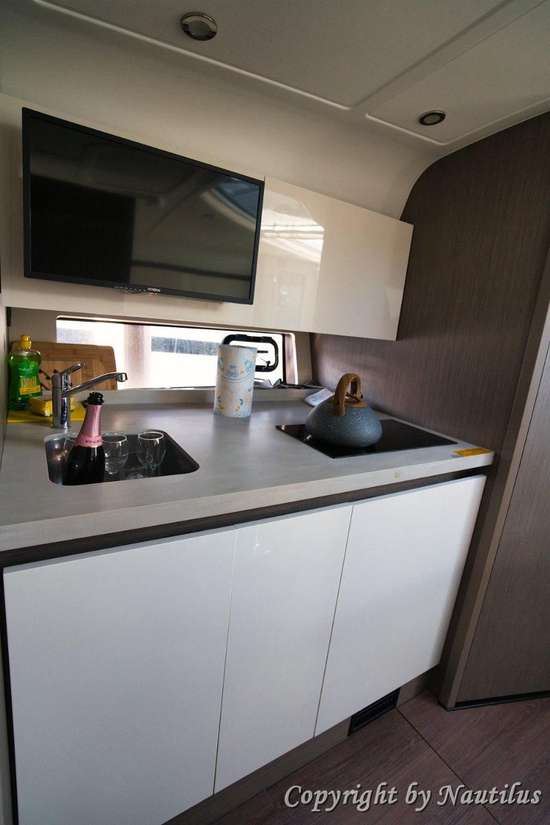 Galley Appliances - Gran Turismo 41 Compact yet functional galley with a hob, sink, and storage for provisions on 'Miami Vice'.