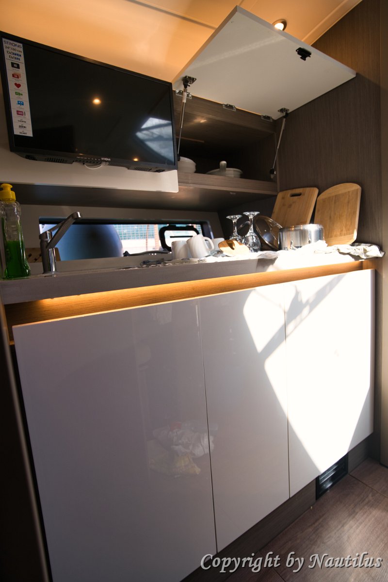 Galley Storage - Beneteau Gran Turismo 41 Smart storage solutions and a refrigerator integrated into the cabinetry of 'Miami Vice'.